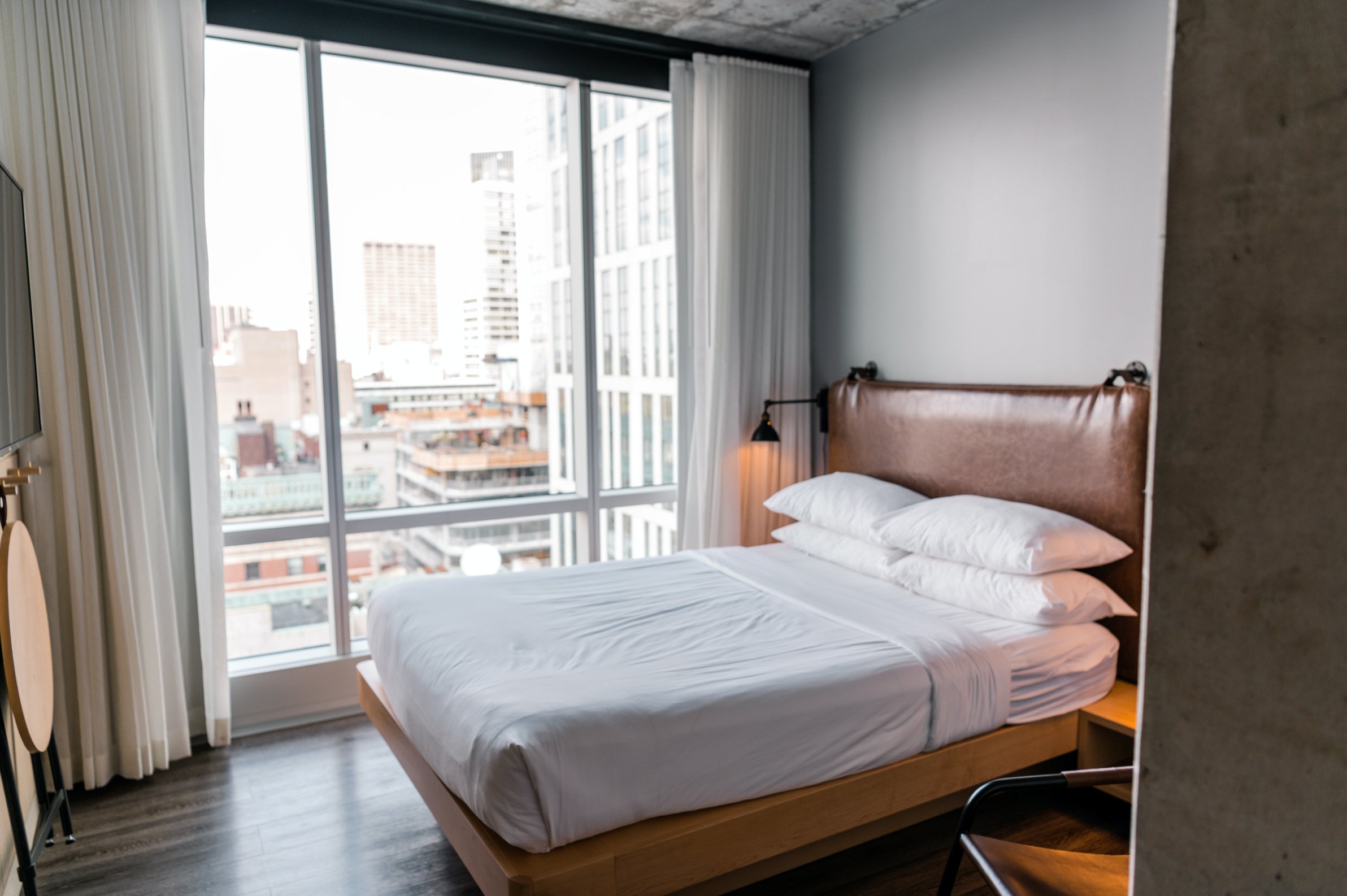 A White Linen on the Bed Near the Glass Window with a View